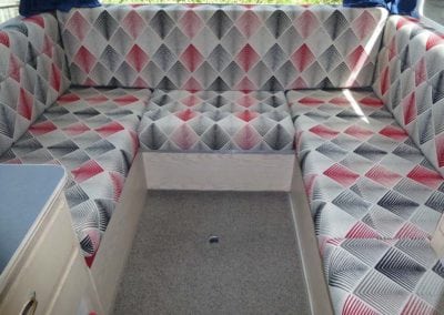 Motorhome seating in red, grey, black and white diamond geometric pattern