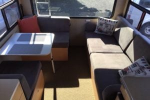 Brown cushions feature in the seating area of motorhome before refurbishment
