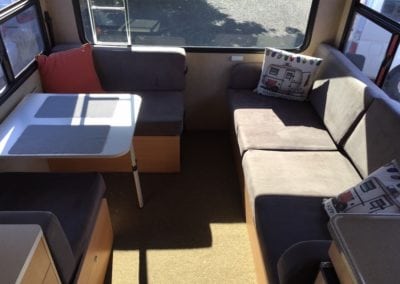 Brown cushions feature in the seating area of motorhome before refurbishment