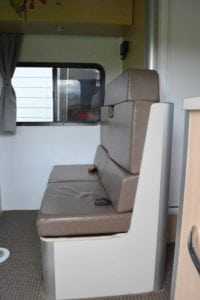 Brown vinyl covered motorhome seating area before refurbishment