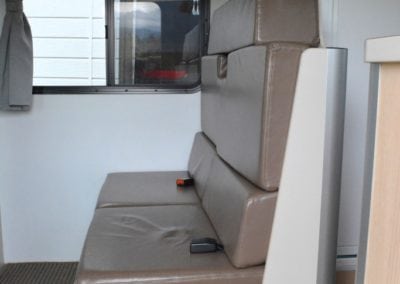 Brown vinyl covered motorhome seating area before refurbishment