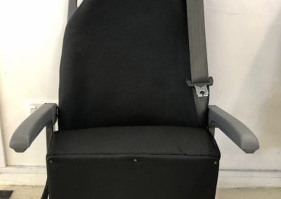 Front view of minivan seat retrimmed in black