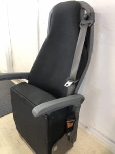 Side view of minivan seat in folded position after refurbishment. Retrimmed in black