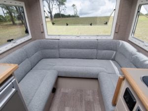 Motorhome seating in grey trim. Grass in background through window