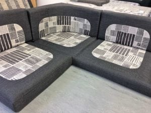 Motorhome corner seating unit in charcoal with grey and white pattern in centre of squab