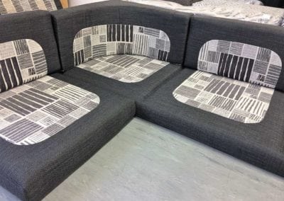 Motorhome corner seating unit in charcoal with grey and white pattern in centre of squab