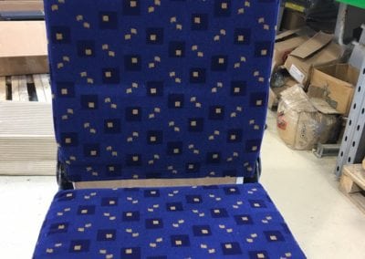 Front view of folding bus seat in open position in factory