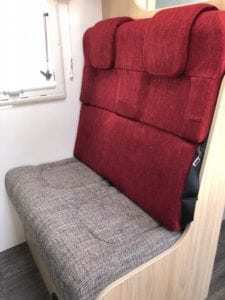 Passenger seating in motorhome trimmed in beige seat with red seat back