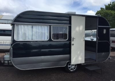 Black and silver caravan with the door open