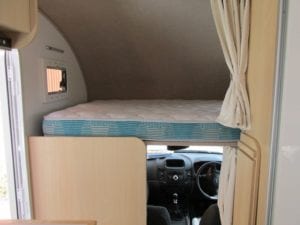 Bed in motorhome with mattress with fabric covered sides