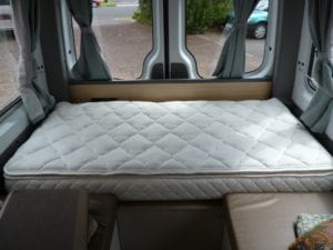 Bed with quilted mattresses in motorhome
