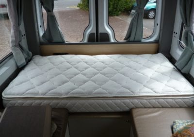 Bed with quilted mattresses in motorhome