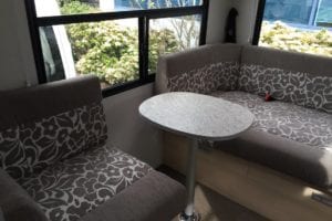 Motorhome lounge two tone cushions with brown floral pattern and plain fabric edges in brown