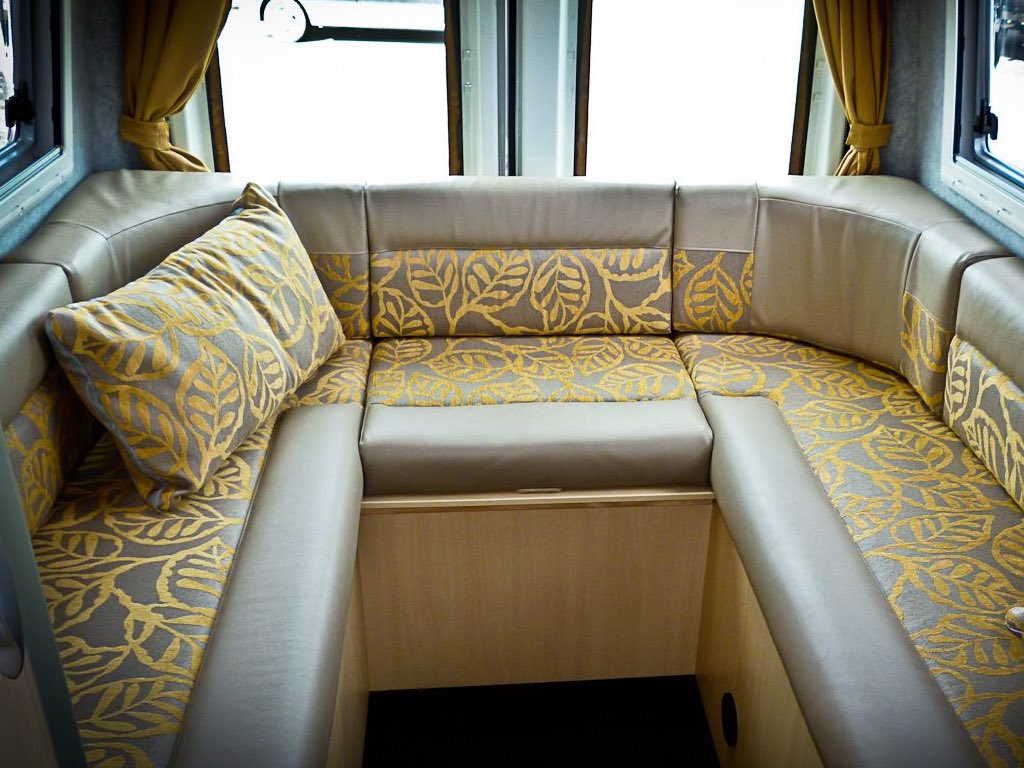 Motorhome lounge two tone cushions with gold leaf pattern and plain fabric edges in brown shade
