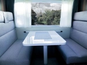 Refurbished dinette seating in grey upholstery with white table