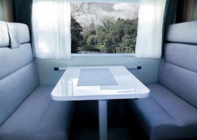 Refurbished dinette seating in grey upholstery with white table