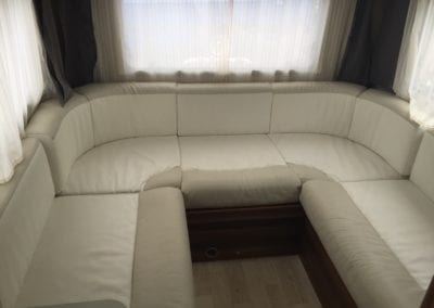 Before refurbishment 6 berth motorhome lounge with baggy, wrinkled beige and cream cushions