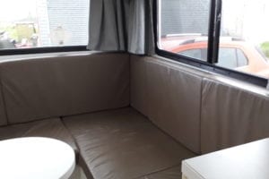 Motorhome rear lounge upholstered in brown vinyl