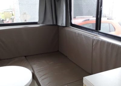 Motorhome rear lounge upholstered in brown vinyl